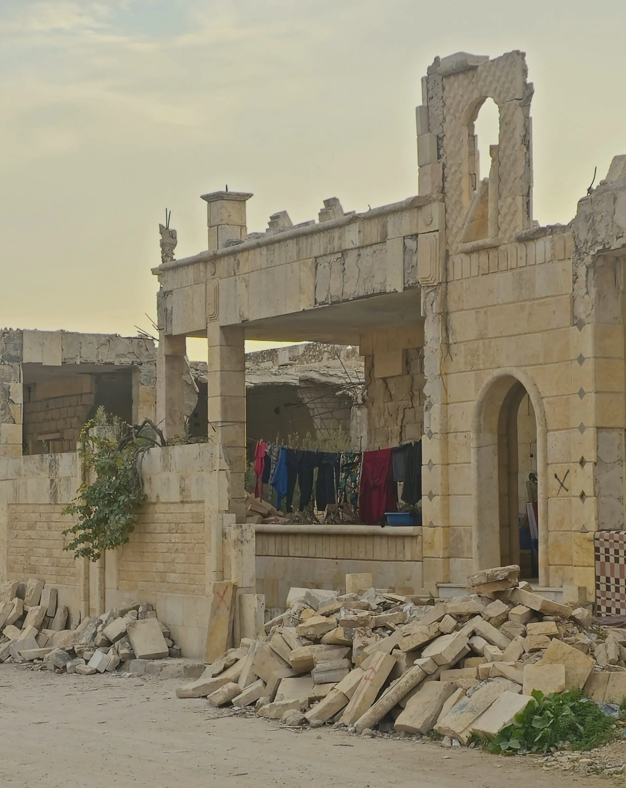 In Syria, people continue to live in the shells of destroyed buildings.