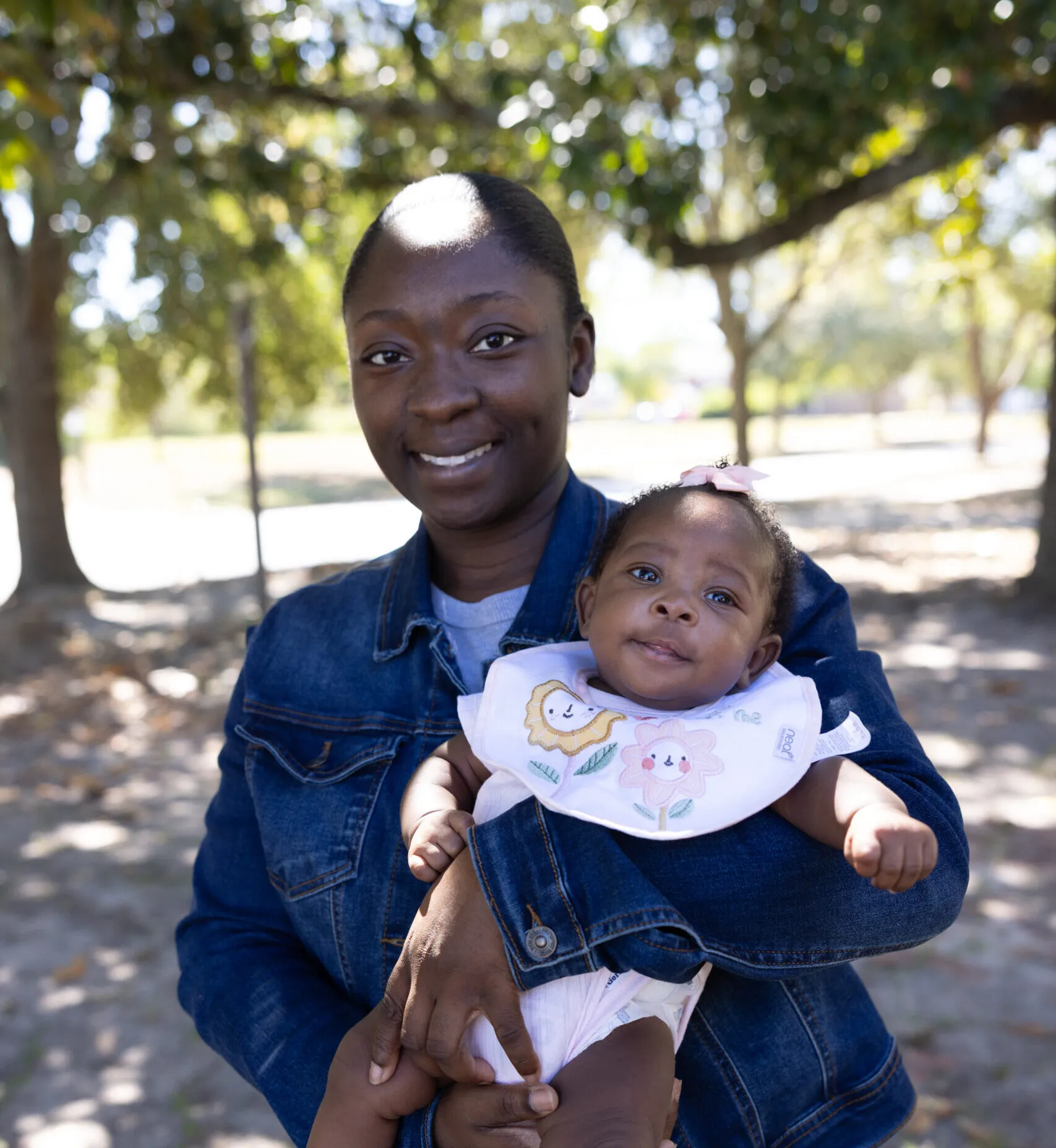 A black American mother holds her young baby.