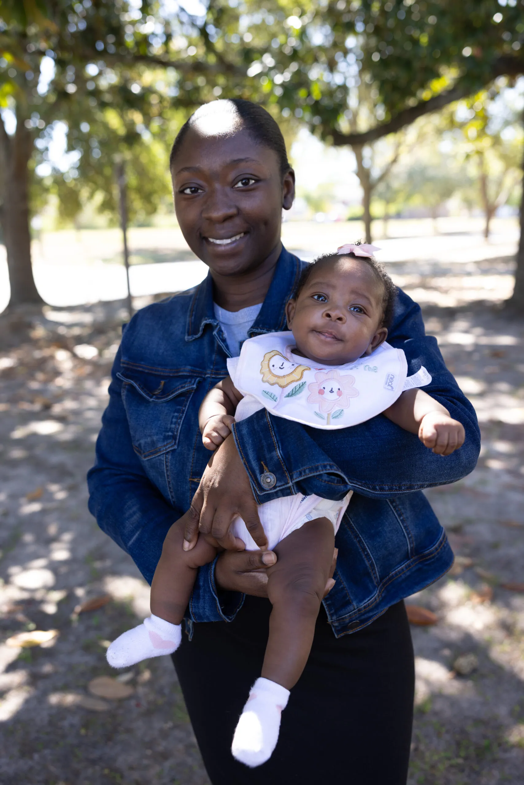 A black American mother holds her young baby.