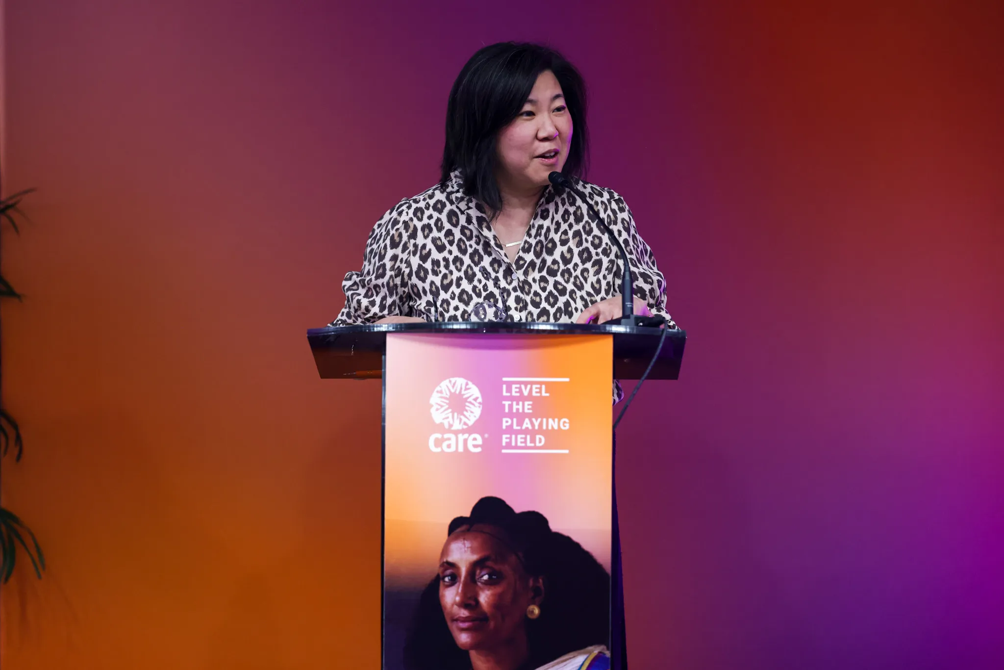 Congresswoman Grace Meng (D-NY) stands at a CARE-branded podium during a CARE on Capitol Hill reception.