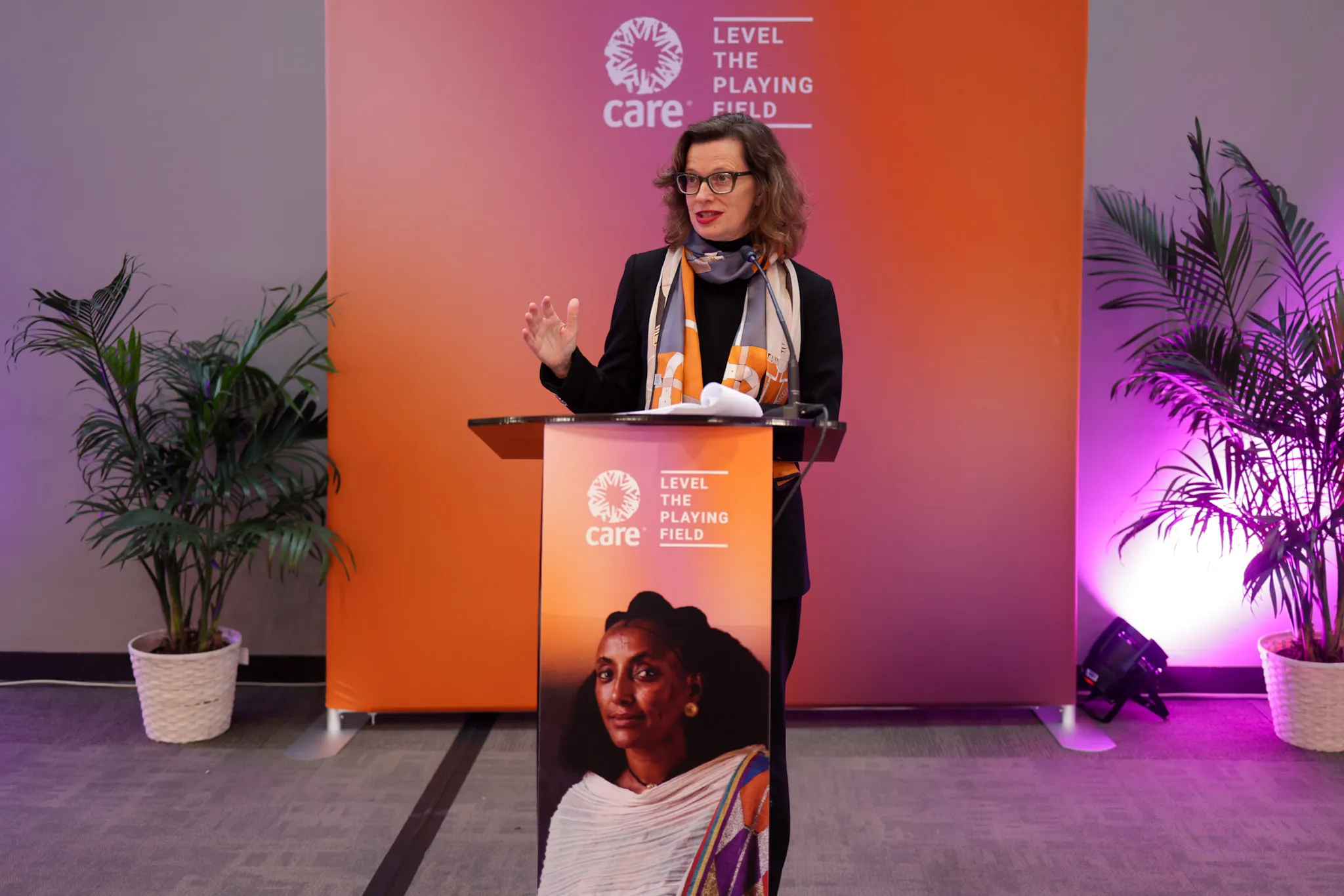 CARE CEO Michelle Nunn stands at a podium during a reception at the Senate office building.