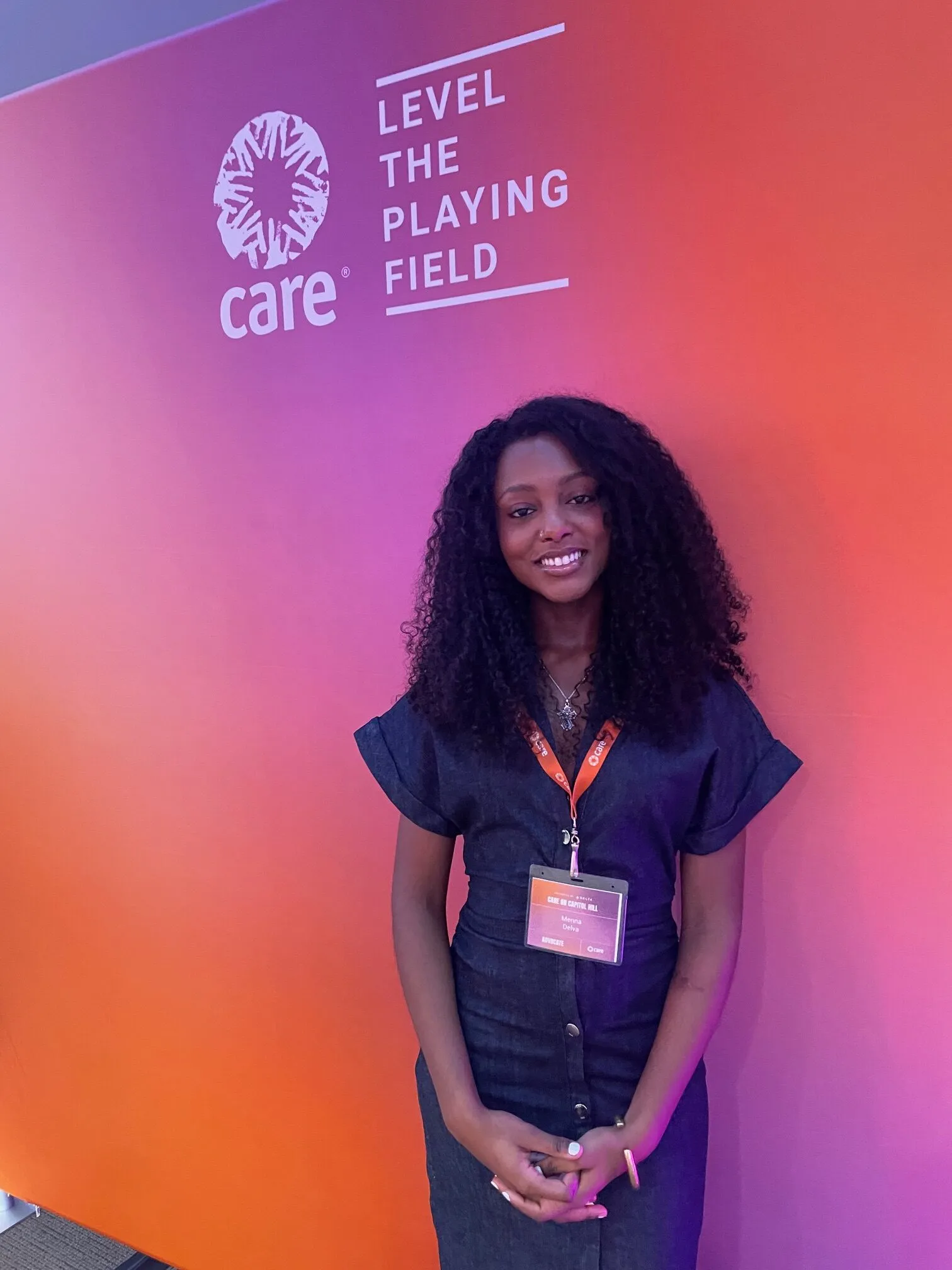 University of Pennsylvania student advocate Meena Delva stands in front of a CARE banner during the CARE on Capitol Hill event.