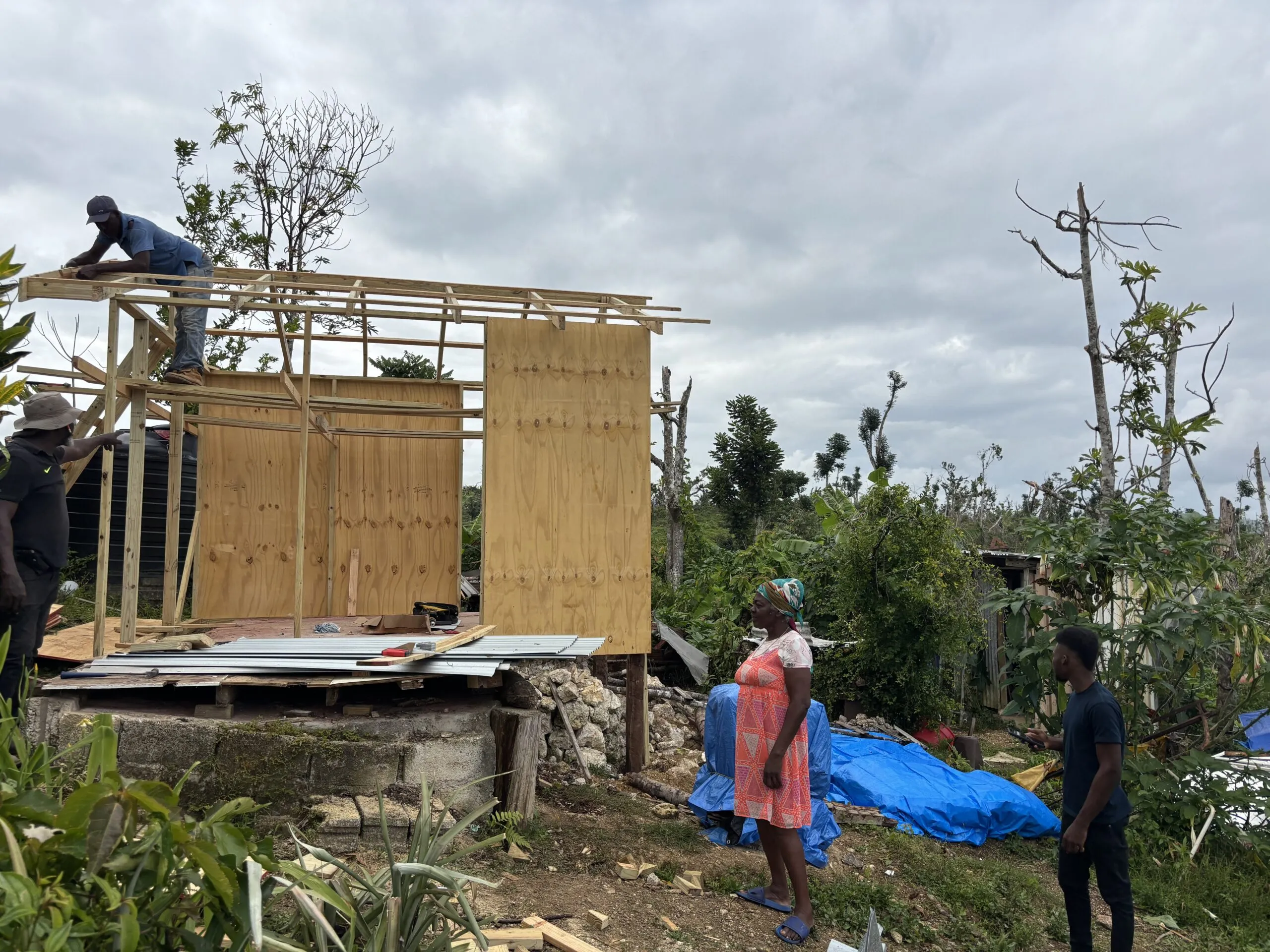 A construction team works to rebuild a home in rural Jamaica.