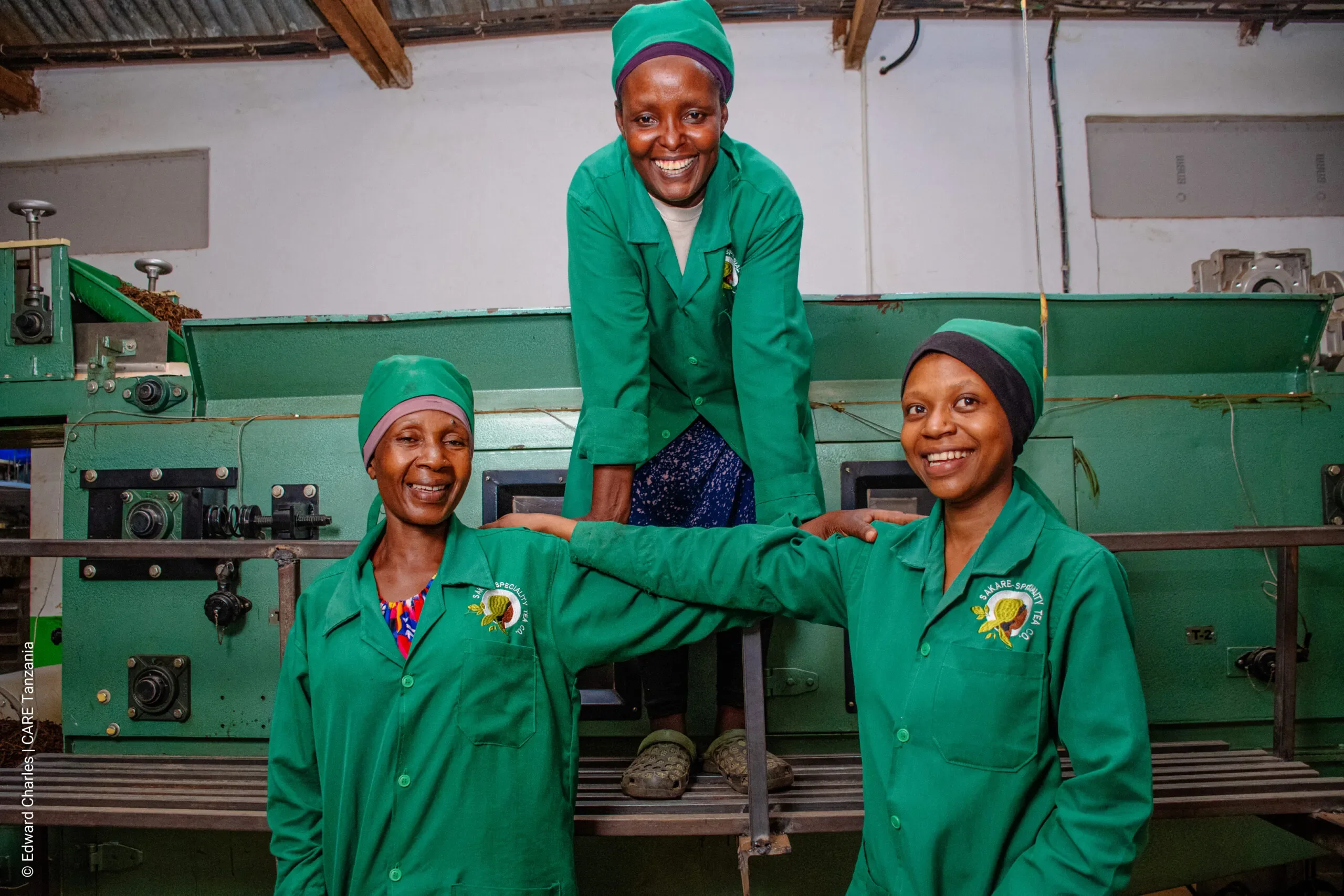 Three women smiling while taking a break at a tea factor