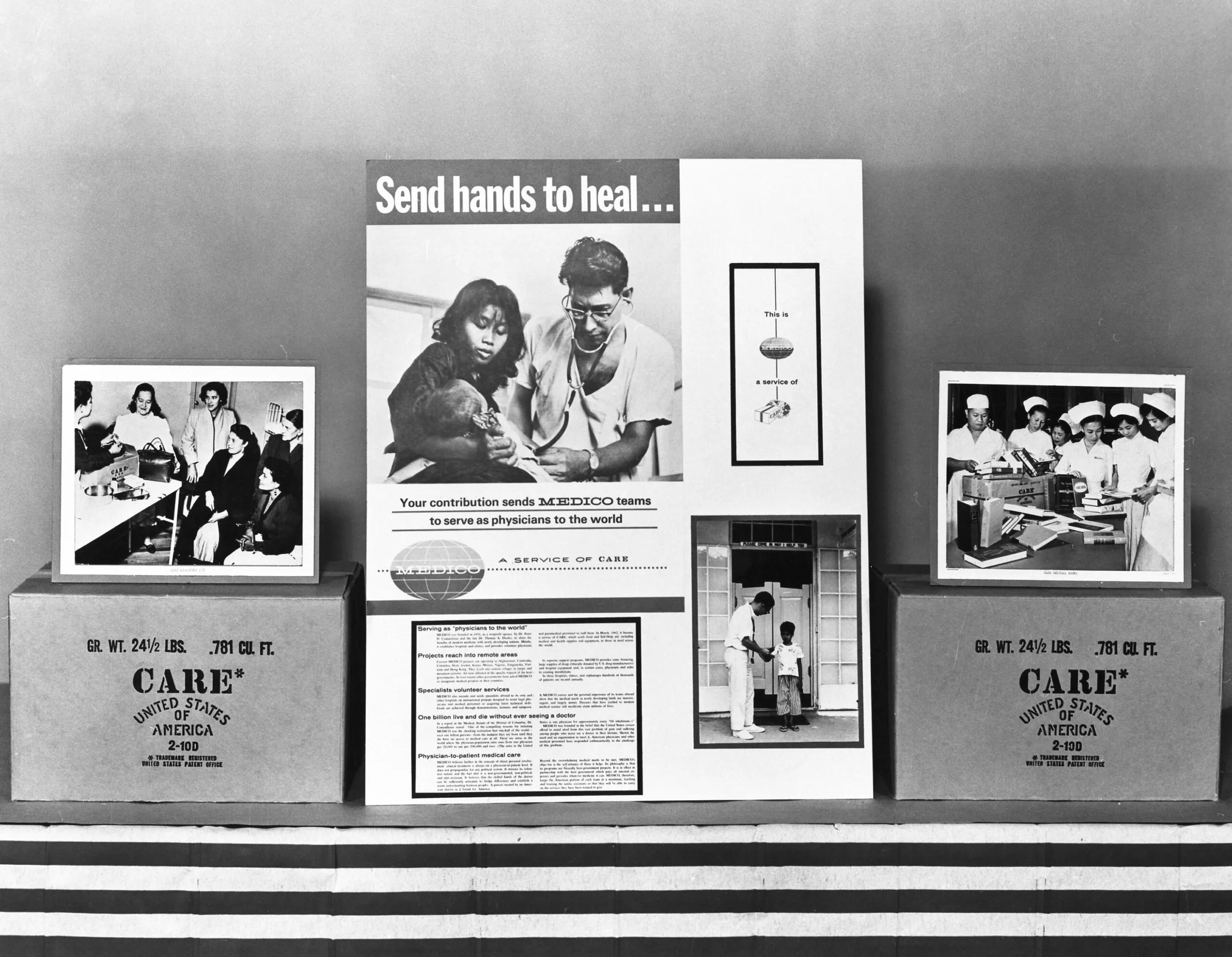 A black and white photo of a CARE ad display for medical aid and CARE PACKAGE boxes.