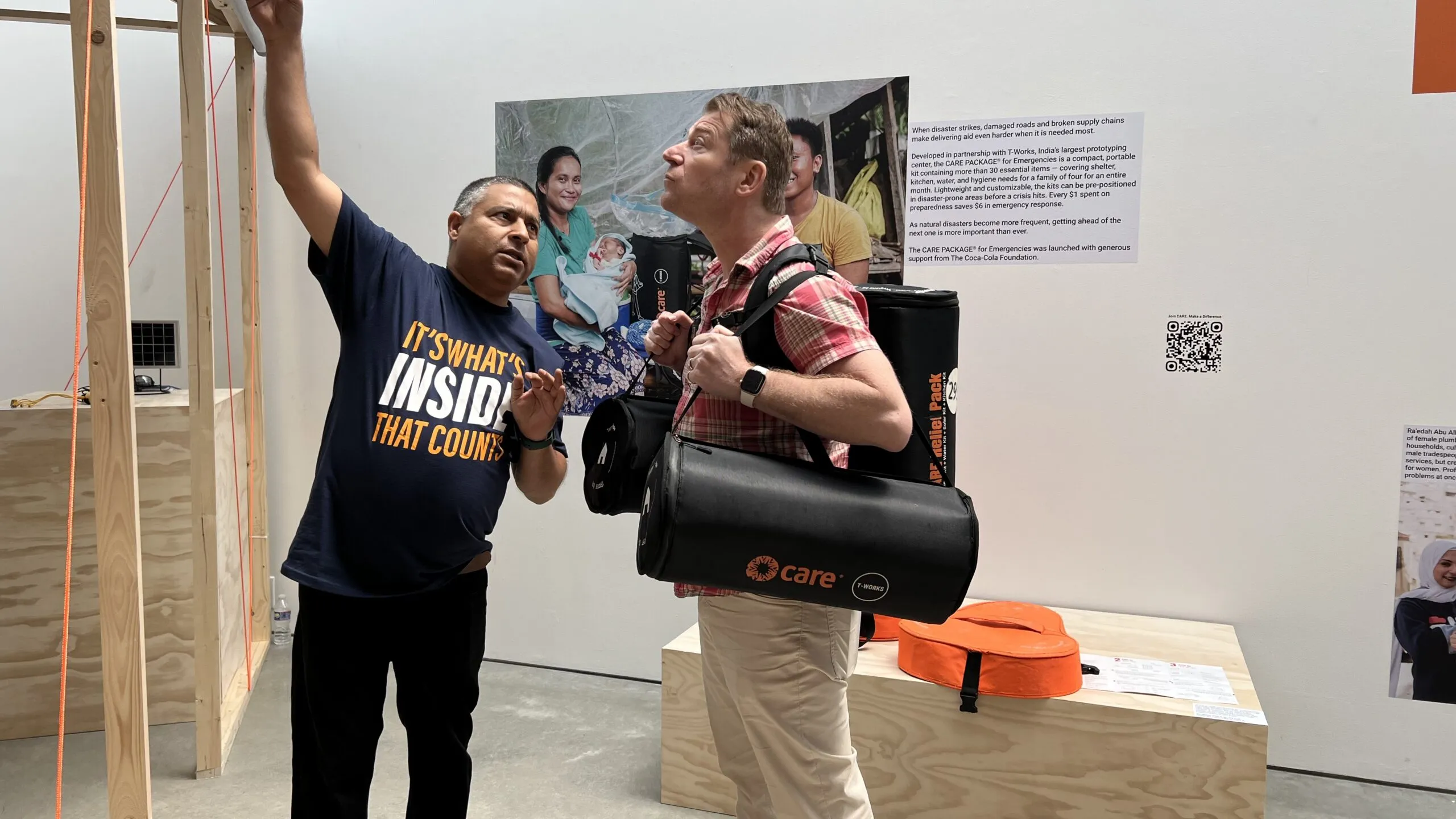 A man talking about an exhibit in a museum to another man.