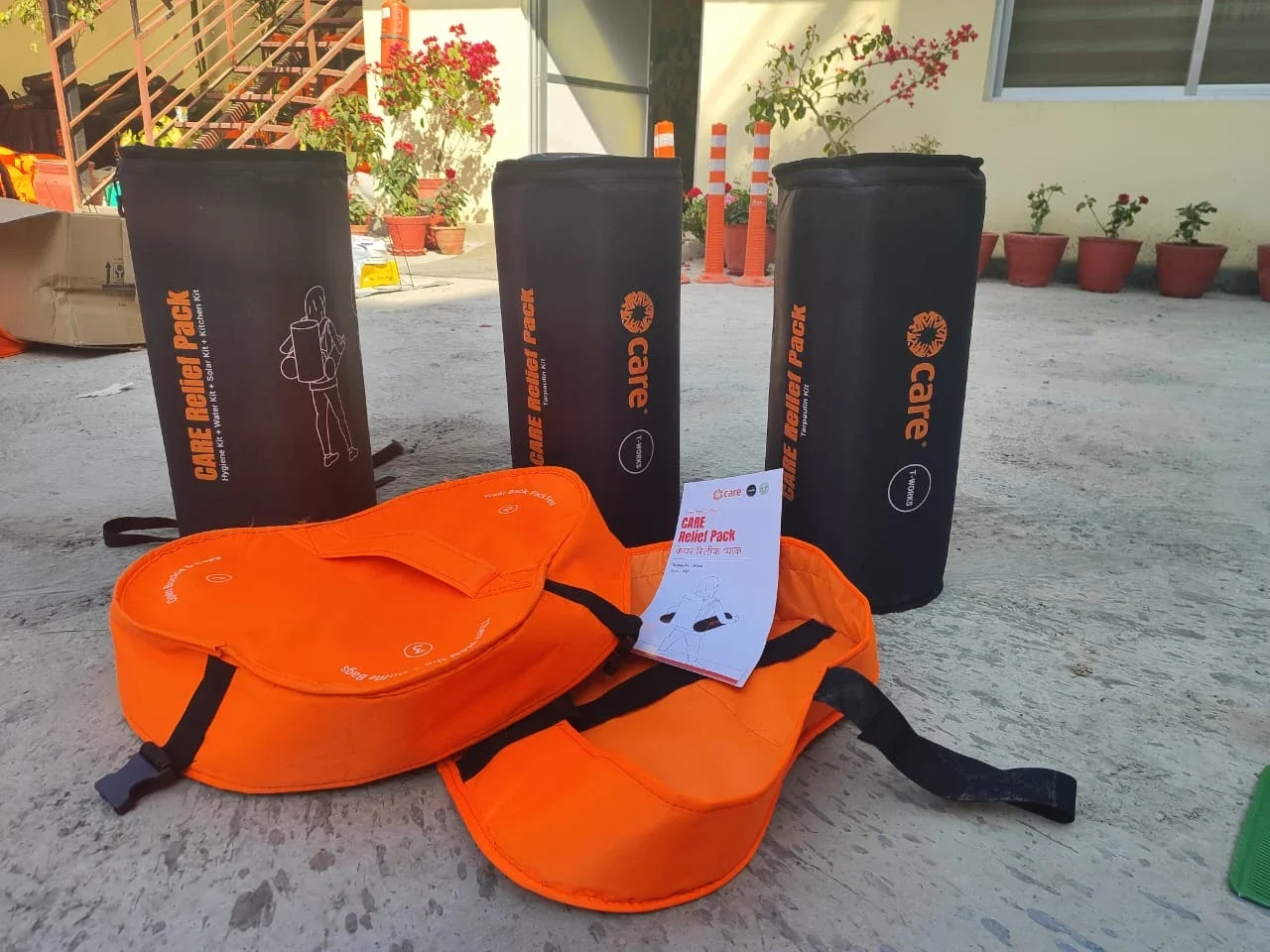 Three large, cylindrical black duffel bags labeled 