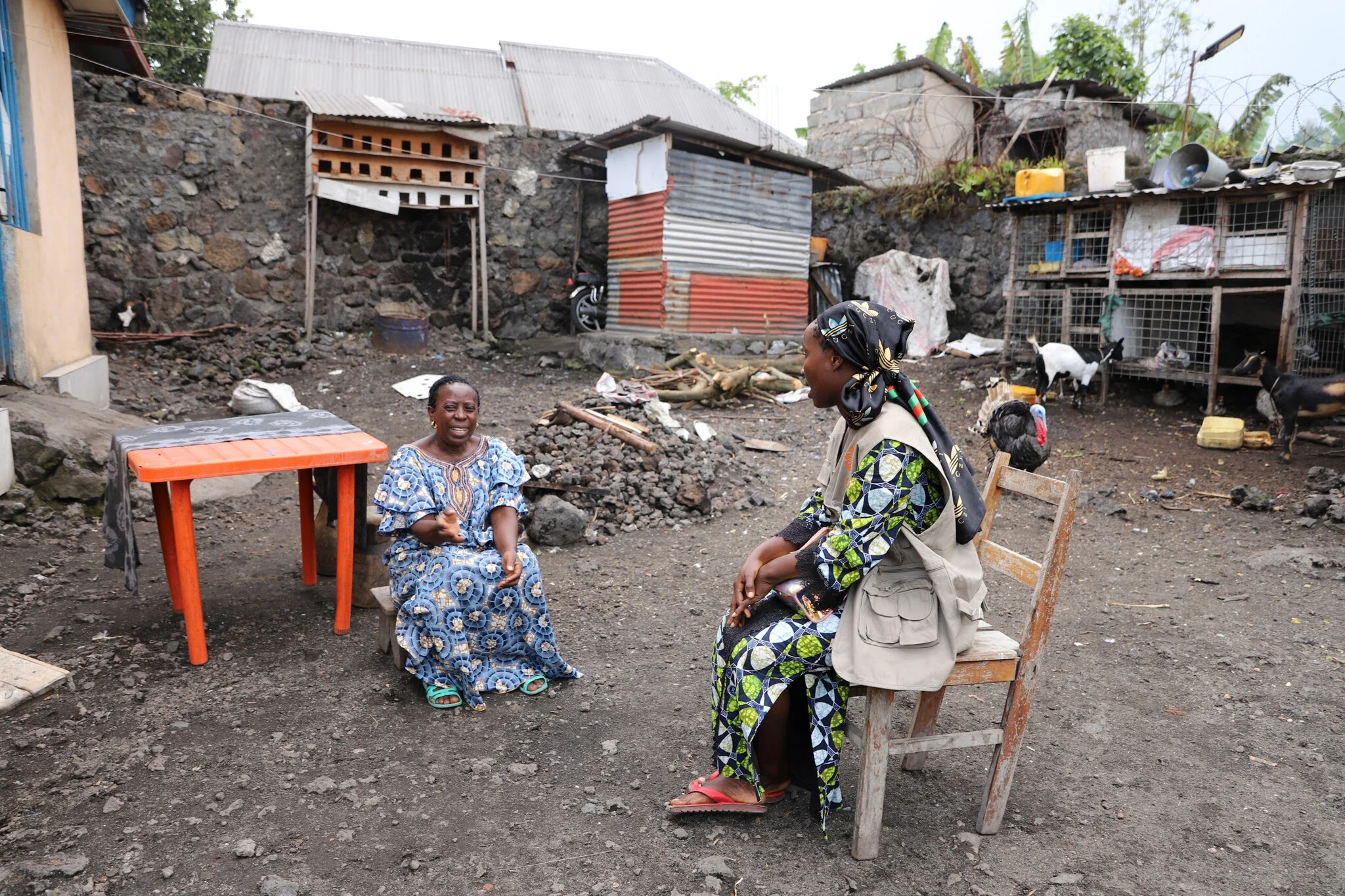 Two women sitting outside having a conversation.