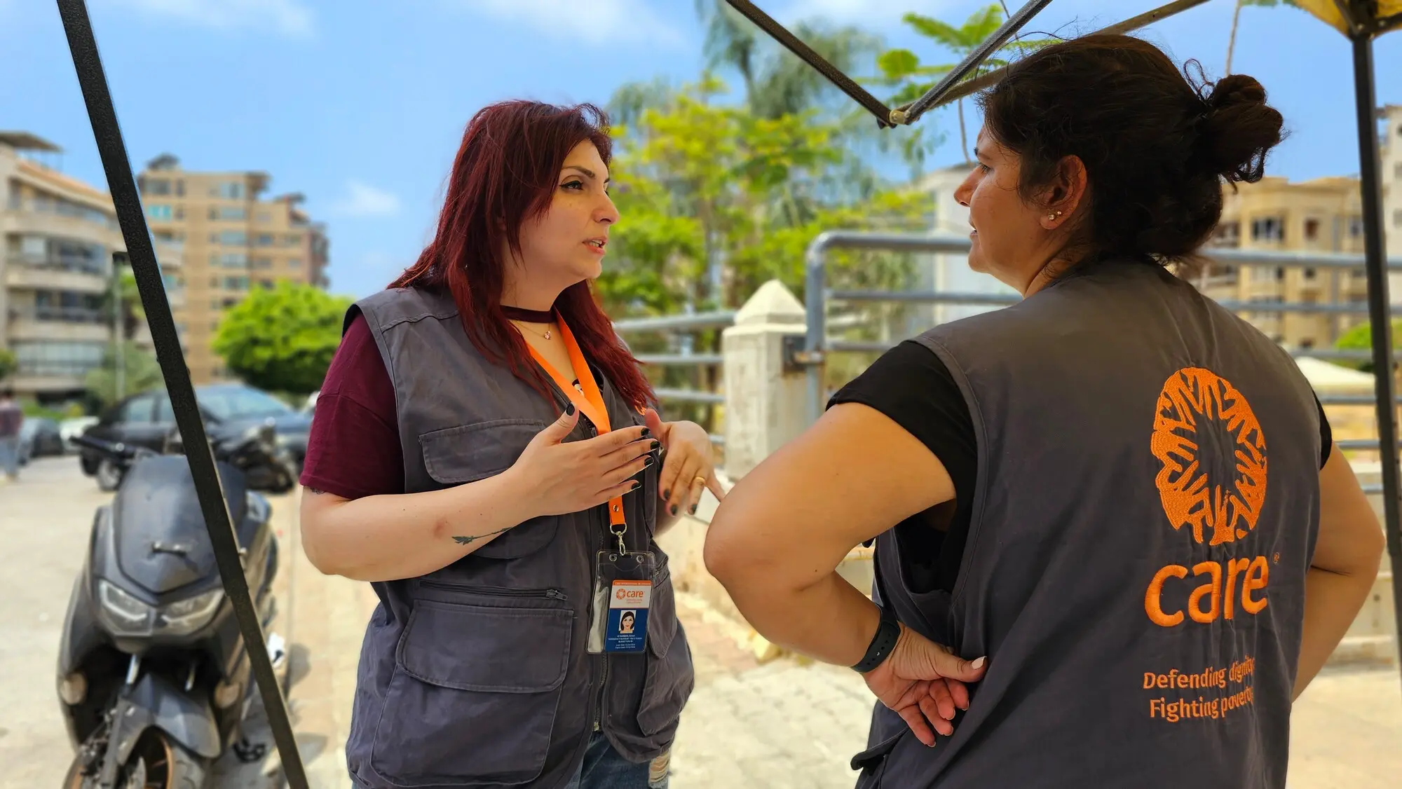 Two women aid workers in Lebanon having a conversation outside.
