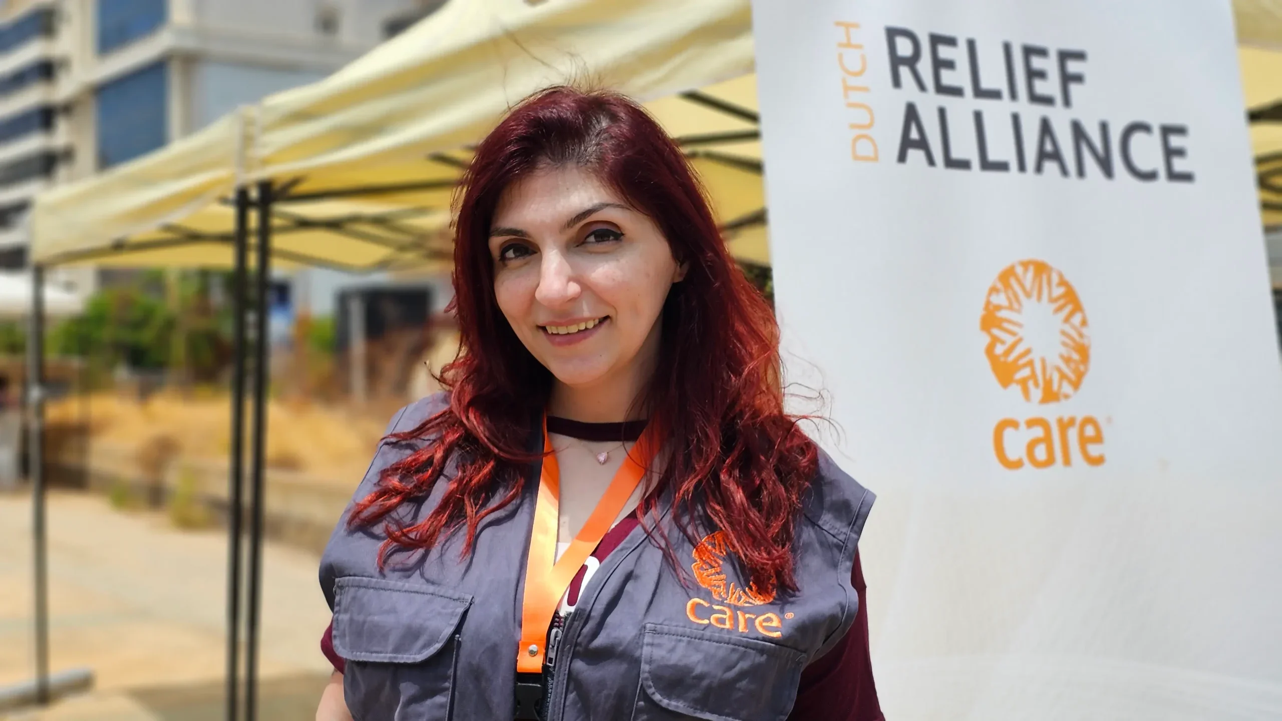 Woman aid worker in Lebanon smiling into the camera.