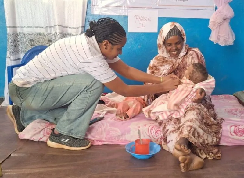 A nurse checks an infant during a growth monitoring visit in Ethiopia.