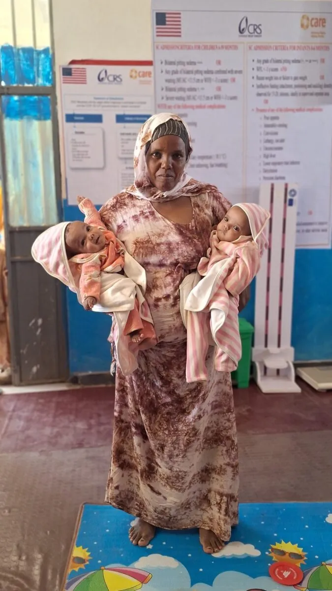 Sefian Hussien holds her infant twins in Ethiopia’s Borena Zone.