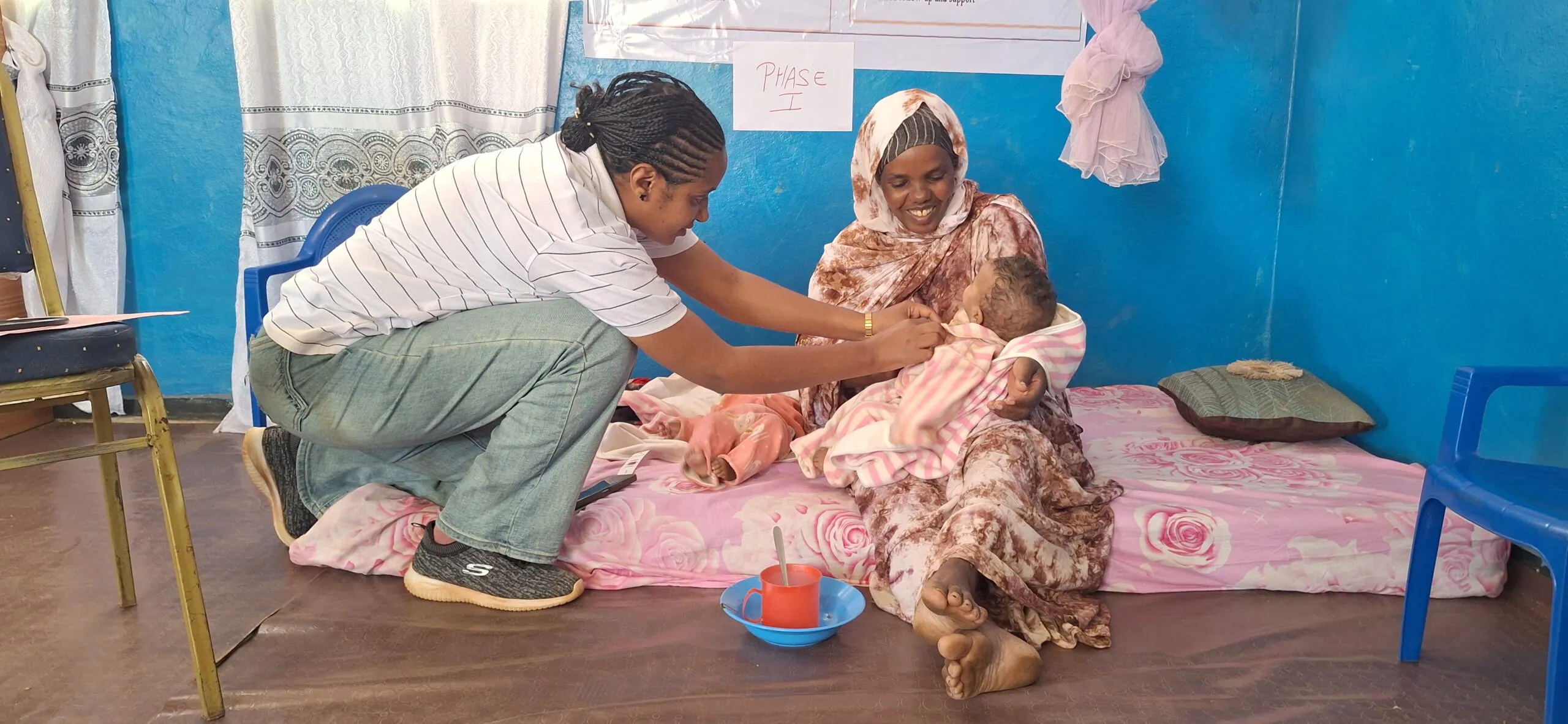 A nurse checks an infant during a growth monitoring visit in Ethiopia.